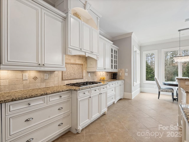 kitchen featuring ornamental molding, white cabinets, light tile patterned flooring, and stainless steel gas cooktop