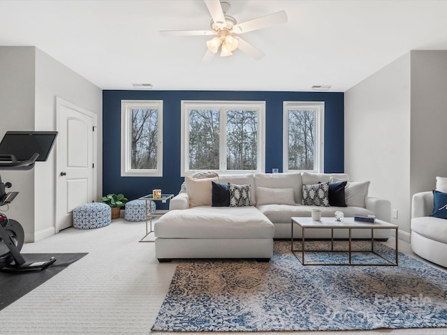 carpeted living room featuring ceiling fan