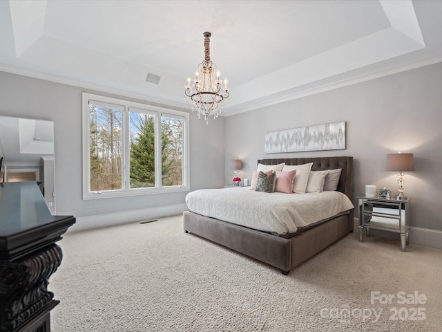 carpeted bedroom with crown molding, a notable chandelier, and a tray ceiling