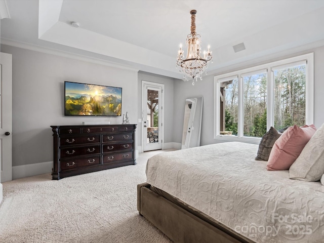 carpeted bedroom featuring a notable chandelier, access to exterior, a raised ceiling, and crown molding