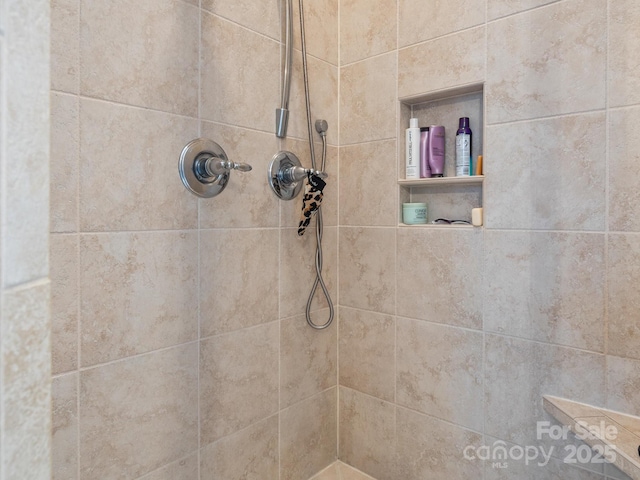 bathroom with a tile shower