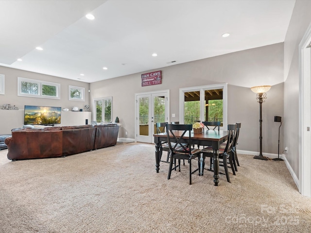 carpeted dining area featuring french doors