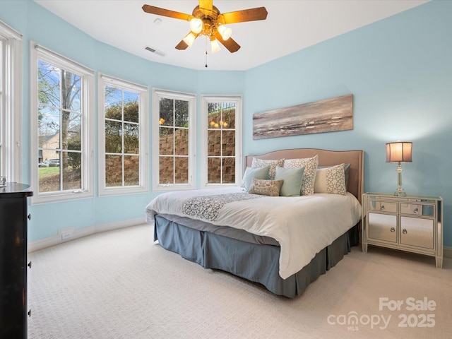 bedroom featuring light colored carpet and ceiling fan