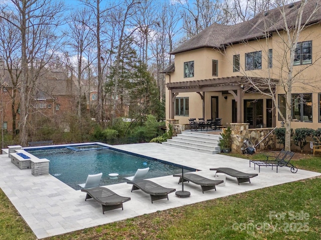 back of property with a pergola and a patio area