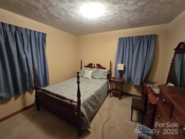 bedroom featuring light carpet and a textured ceiling