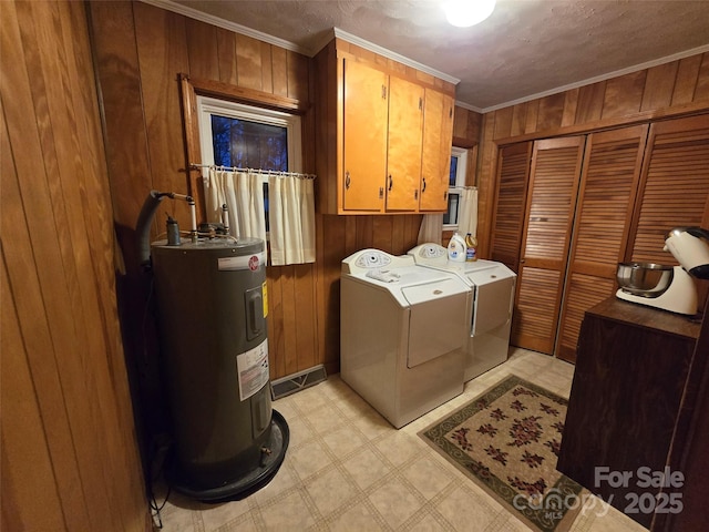 washroom featuring washer and clothes dryer, water heater, ornamental molding, and cabinets