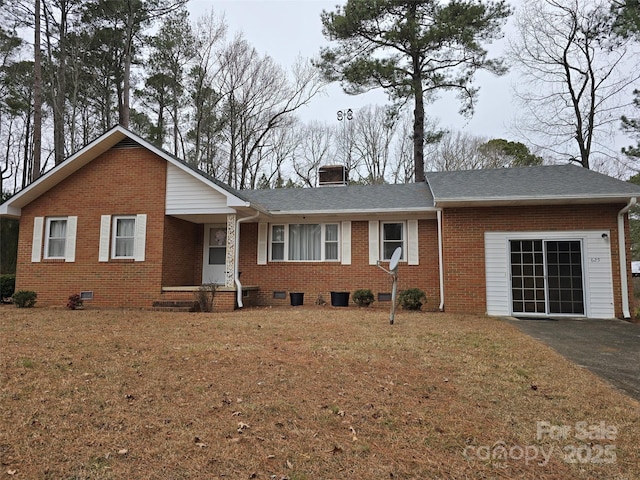 single story home with a front yard and a garage