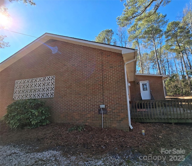 view of side of property featuring a wooden deck