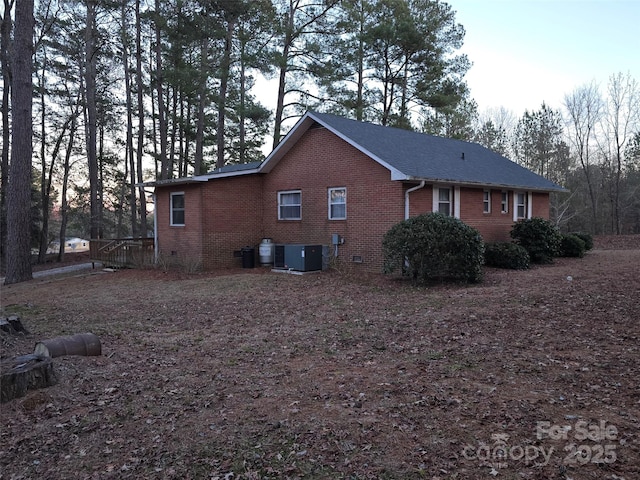 view of side of home featuring central AC unit