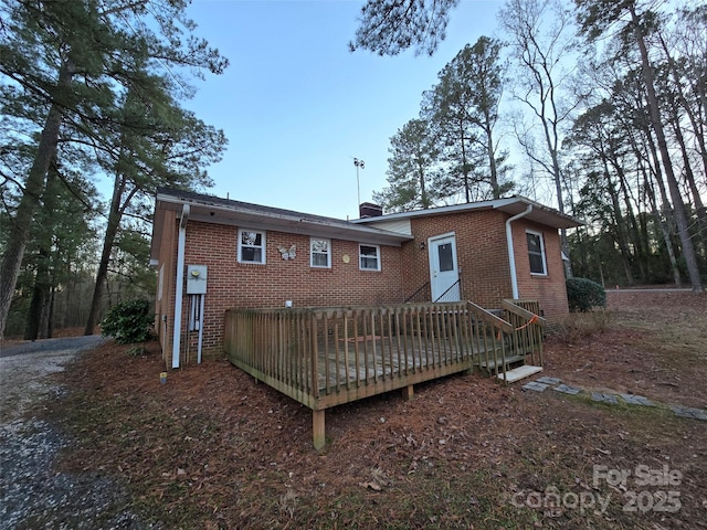 rear view of house with a wooden deck