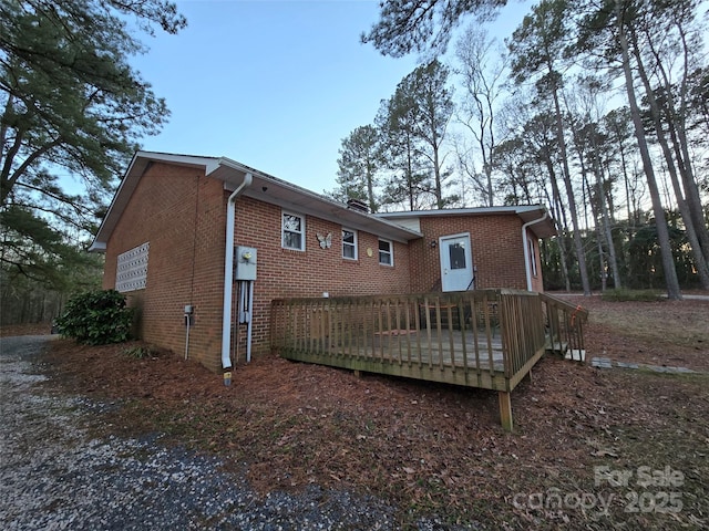 back of house featuring a deck