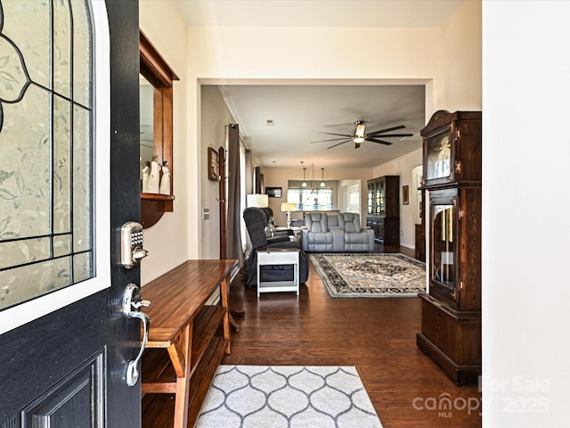 interior space featuring ceiling fan and dark hardwood / wood-style flooring