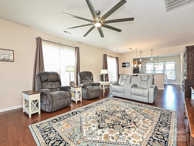 living room featuring dark wood-type flooring and ceiling fan