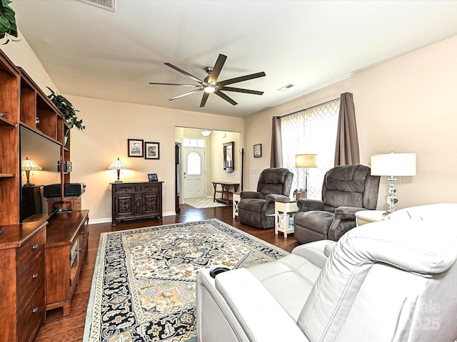 living room featuring dark hardwood / wood-style floors and ceiling fan