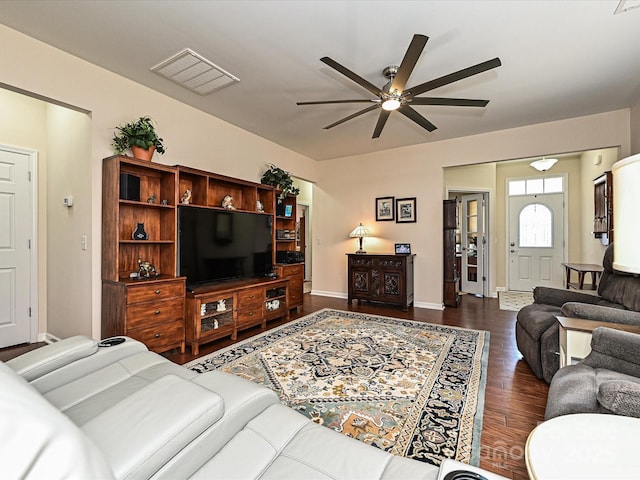 living room with dark wood-type flooring and ceiling fan