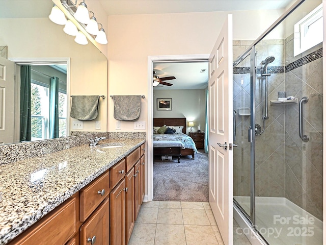 bathroom featuring an enclosed shower, vanity, tile patterned floors, and ceiling fan