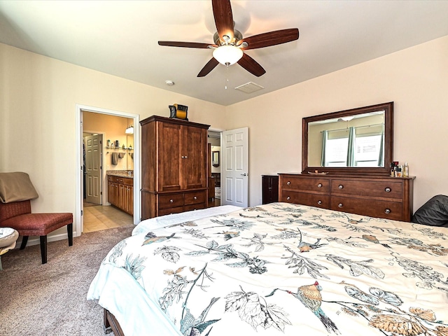 carpeted bedroom featuring ceiling fan and ensuite bath