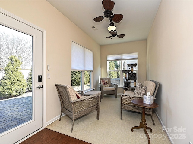 living area featuring ceiling fan and wood-type flooring