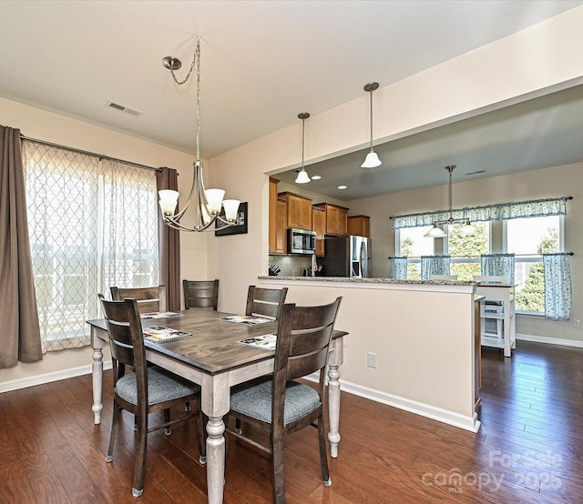 8024 Carolina Lakes Way, Fort Mill, SC 29707 - dining area with a chandelier, dark wood finished floors, and baseboards