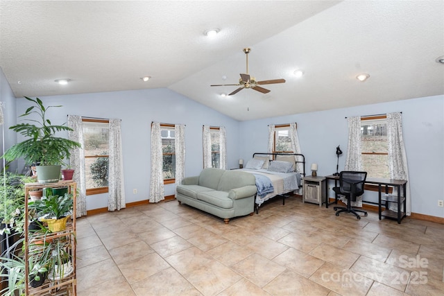 bedroom featuring vaulted ceiling, ceiling fan, a textured ceiling, and baseboards