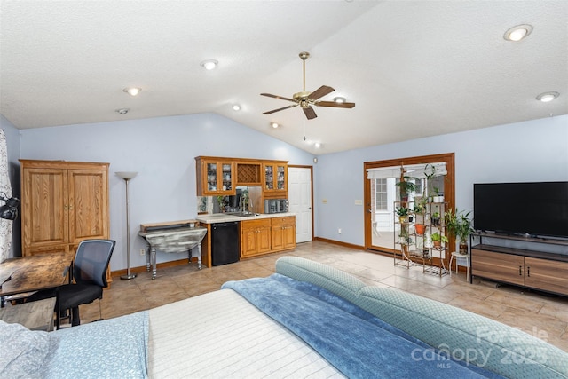 bedroom featuring baseboards, a ceiling fan, access to outside, vaulted ceiling, and a sink