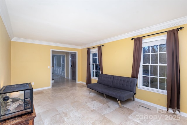 sitting room with crown molding, visible vents, and baseboards