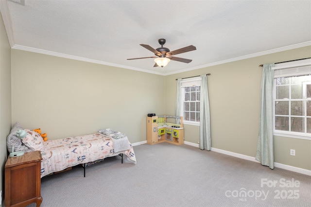 unfurnished bedroom featuring crown molding, carpet, a ceiling fan, and baseboards