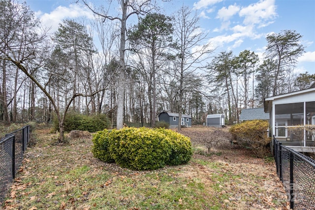 view of yard with fence and a sunroom