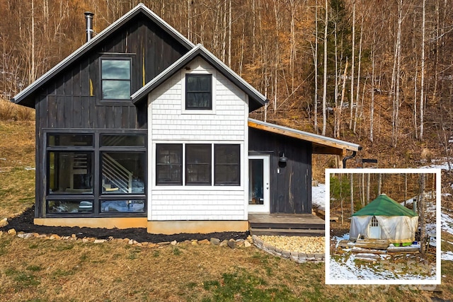 rear view of property with a sunroom