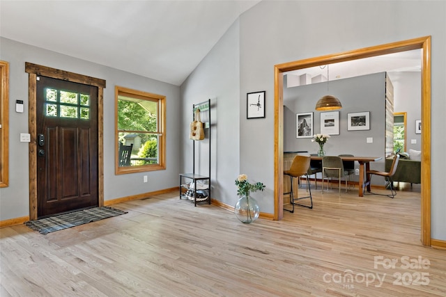 entryway with light hardwood / wood-style flooring and lofted ceiling