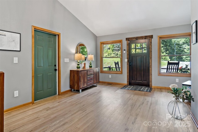 entryway featuring light wood-type flooring and lofted ceiling