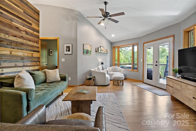 living room with lofted ceiling, ceiling fan, and hardwood / wood-style floors