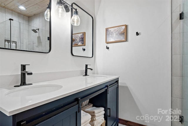 bathroom featuring walk in shower and vanity