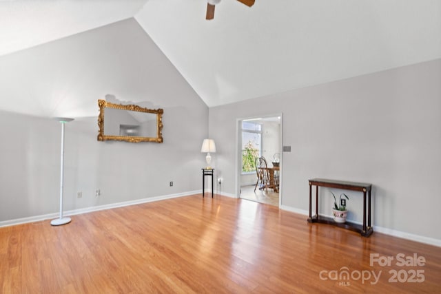 unfurnished living room featuring hardwood / wood-style flooring, vaulted ceiling, and ceiling fan