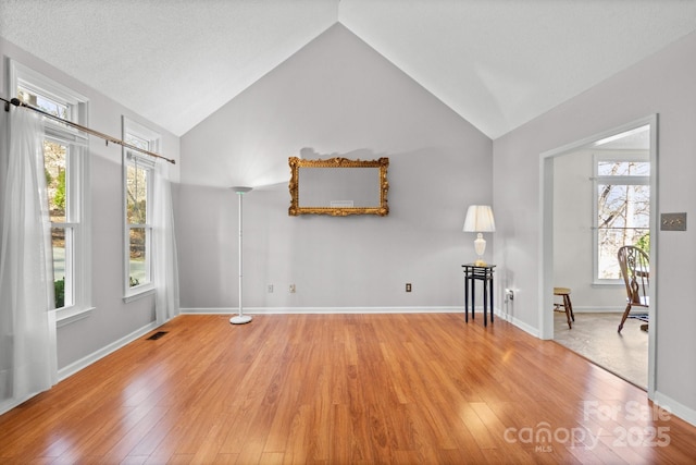 interior space featuring high vaulted ceiling and light wood-type flooring