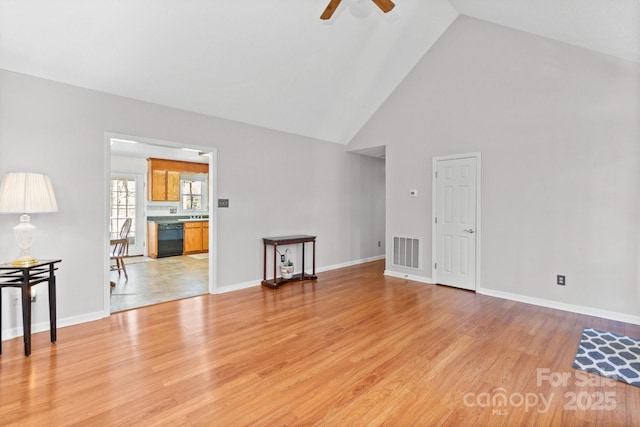 unfurnished living room with hardwood / wood-style flooring, high vaulted ceiling, and ceiling fan