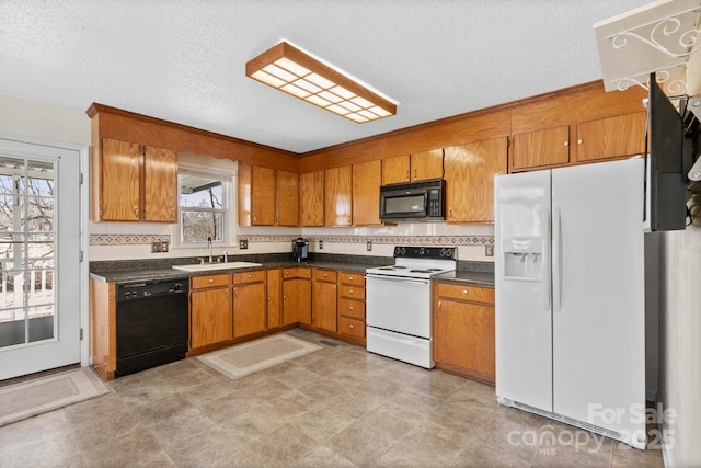 kitchen featuring sink, decorative backsplash, black appliances, and a textured ceiling