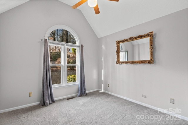 carpeted spare room with ceiling fan and lofted ceiling