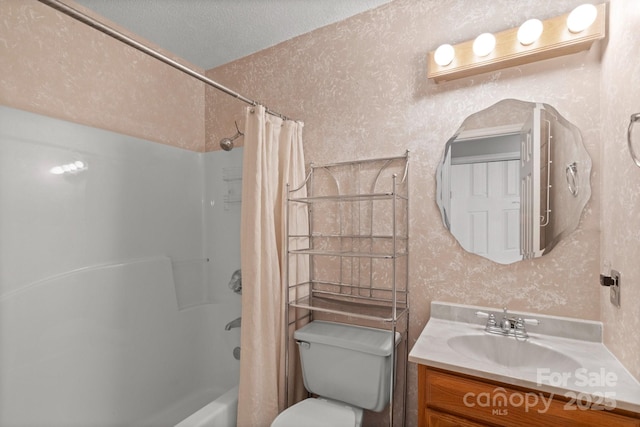 full bathroom with vanity, a textured ceiling, shower / bath combination with curtain, and toilet