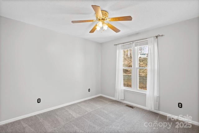 carpeted empty room with a textured ceiling and ceiling fan