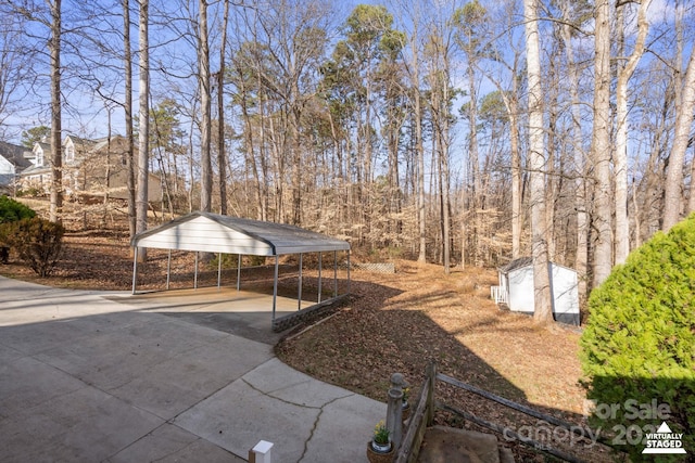 view of yard with a carport and a storage unit