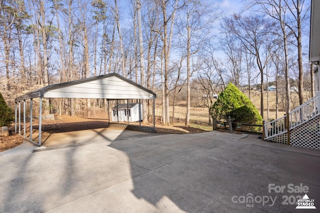 view of patio featuring a carport and a shed