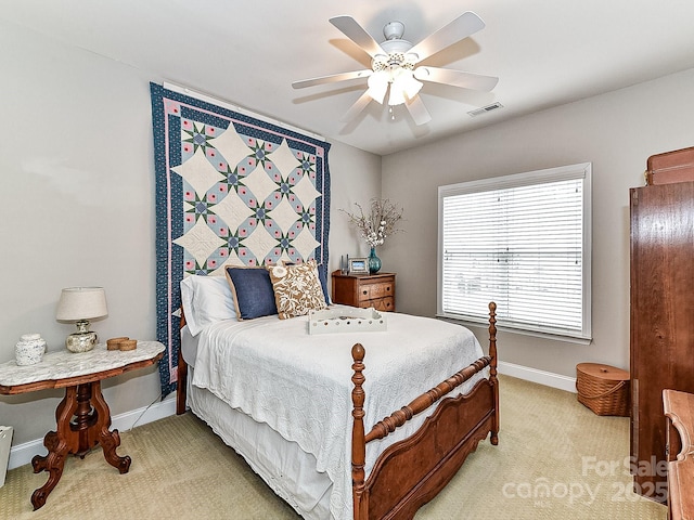 bedroom with ceiling fan and light carpet