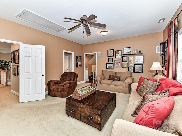 carpeted living room with ceiling fan