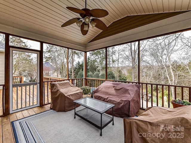 sunroom / solarium with wood ceiling, ceiling fan, and lofted ceiling