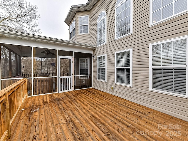 wooden terrace featuring a sunroom and ceiling fan