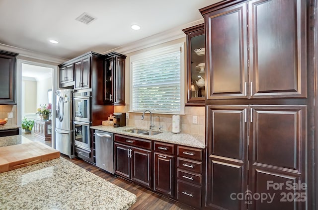 kitchen with sink, appliances with stainless steel finishes, dark hardwood / wood-style floors, and crown molding