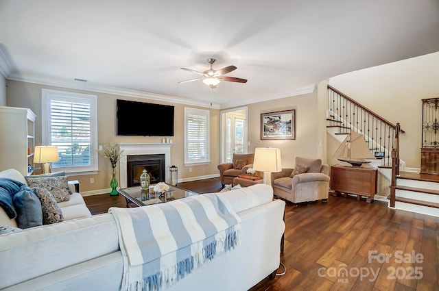 living room with crown molding, dark hardwood / wood-style floors, and ceiling fan