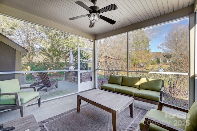 unfurnished sunroom featuring ceiling fan