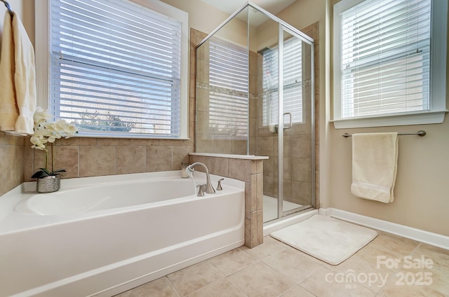 bathroom featuring plenty of natural light, plus walk in shower, and tile patterned flooring